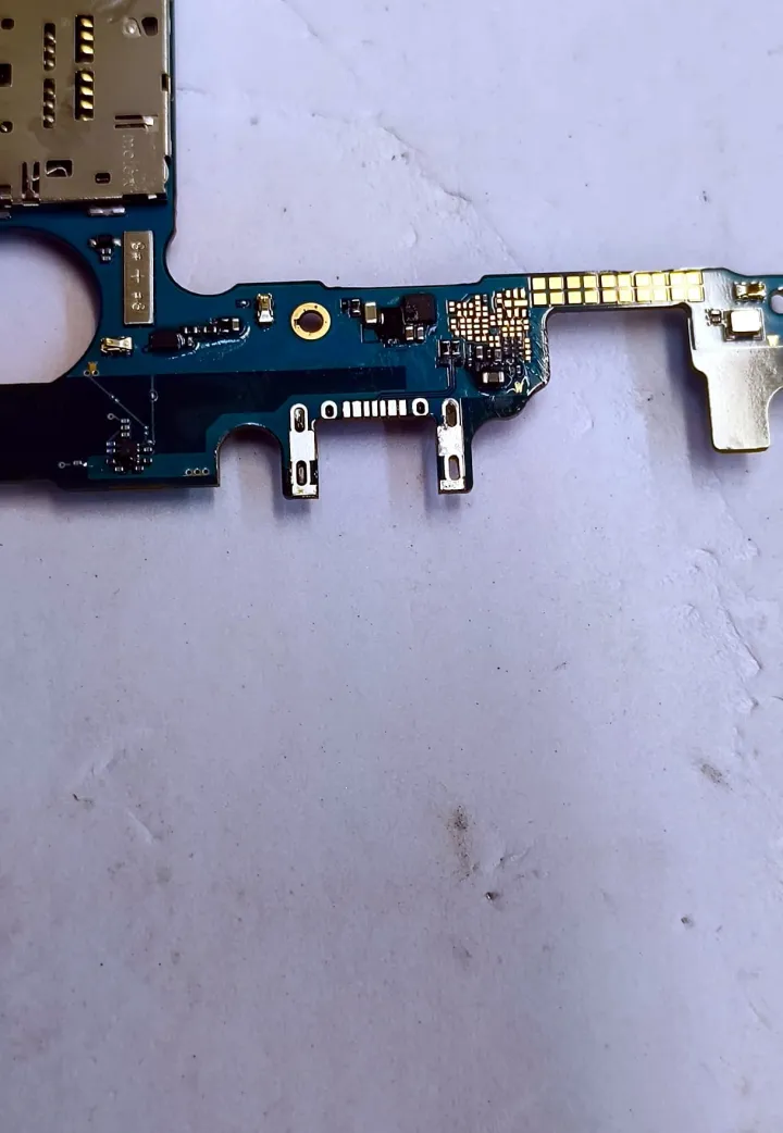 Scheda di ricarica di Samsung SM-J600 appoggiata sul banco tecnico.